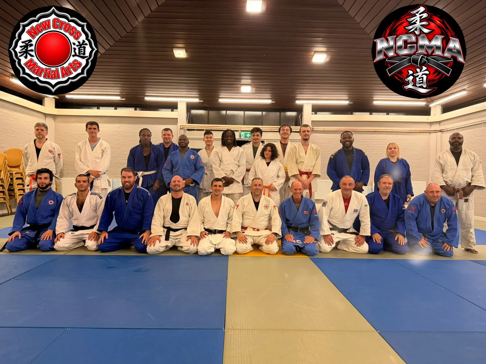 New Cross Martial Arts class photo in the hall, NCMA logos in the corners