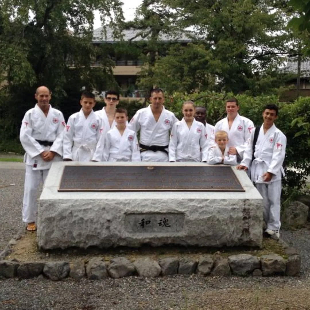 NCMA group in judogi at a stone monument, Kyoto, Japan
