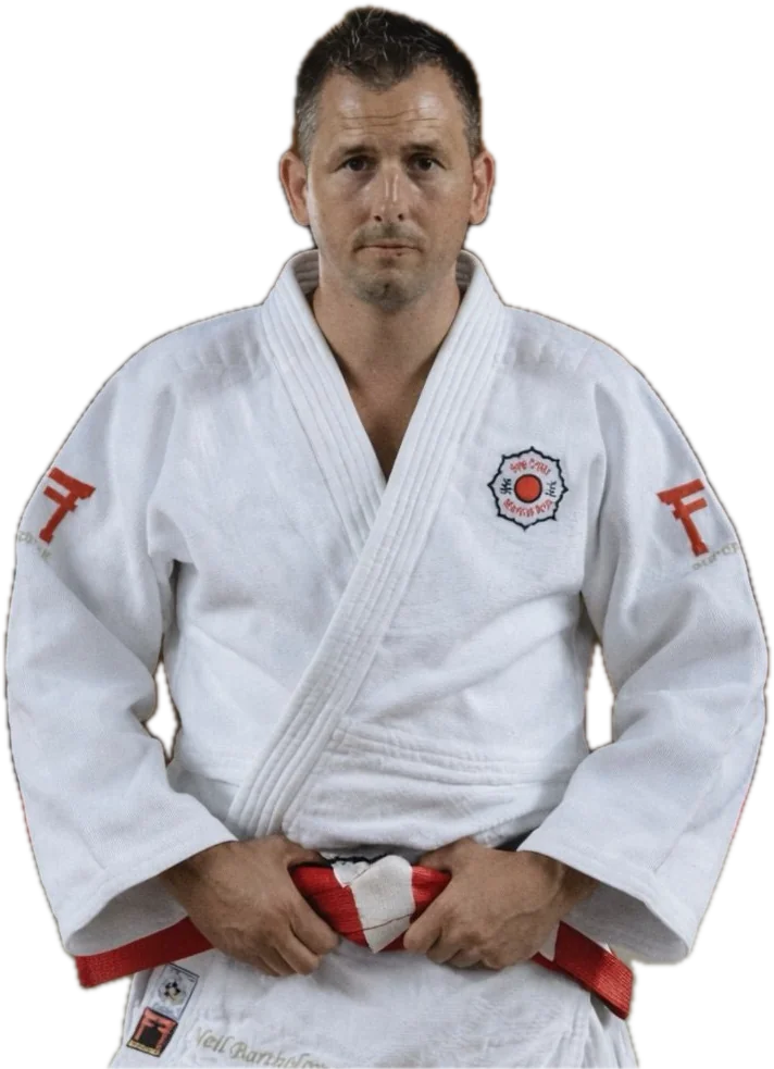 Neil Bartholomew in a white judogi with a red and white belt